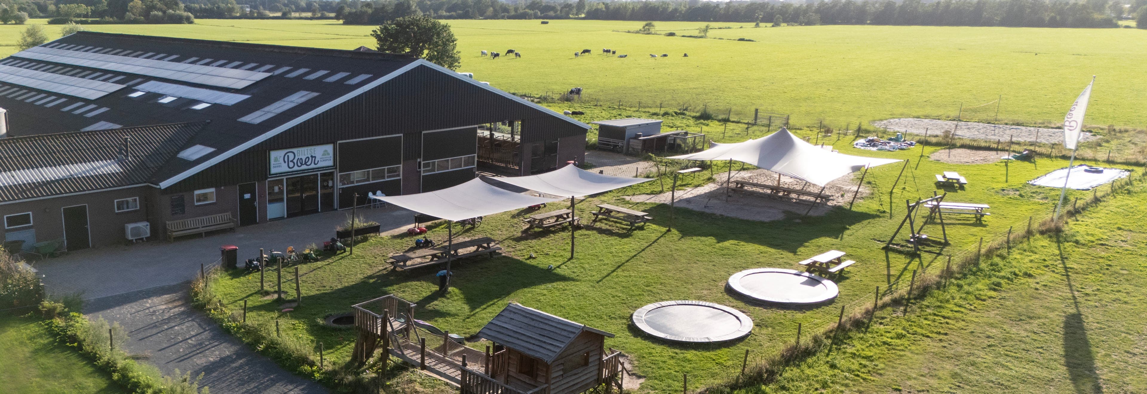 Aerial view of the Biltse Boer farmyard: the parlour, the terrace and the play meadow, with the cows in the field behind